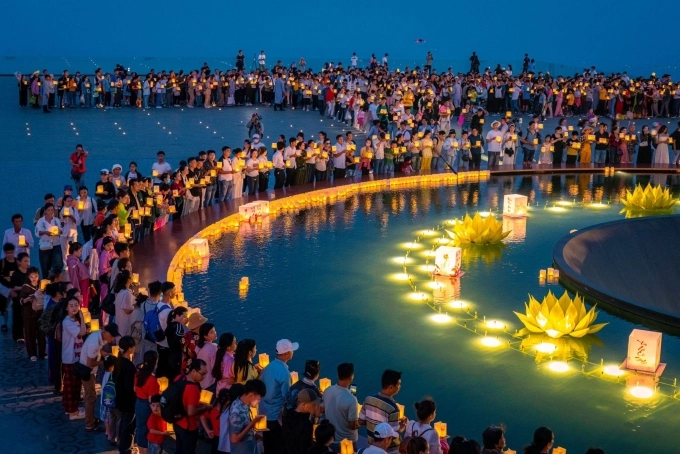 Dòng người thả đèn đăng tại đĩa nước giữa quảng trường trên đỉnh núi Bà Đen. Ảnh: Minh Tú