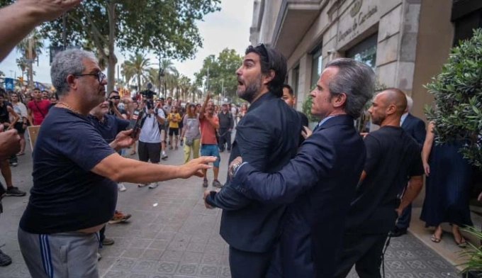 Một người đàn ông cãi nhau với người biểu tình bên ngoài một khách sạn ở Barcelona, Tây Ban Nha vào mùa hè 2024. Ảnh: AFP
